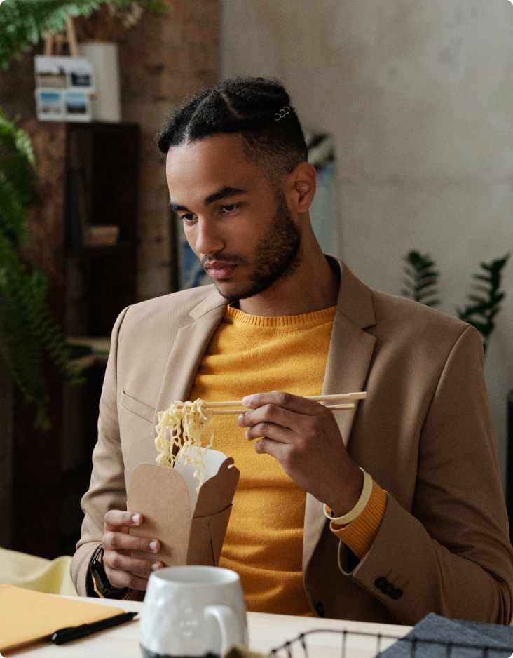 man eating noodles